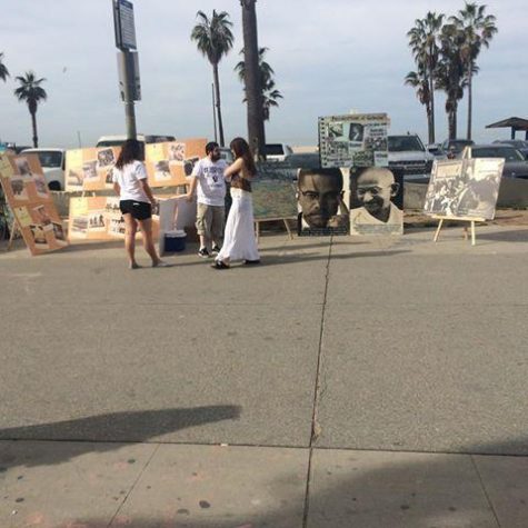 AYF members post up informational posters in Venice Beach. 