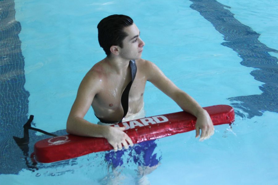 Paul Terzian in the pool with a rescue tube.
