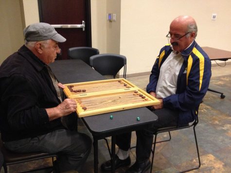 Two members playing "nardi" in one of the activity rooms.