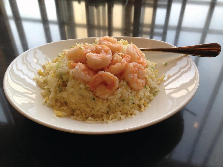 A lunch of fried white rice topped off with shrimp.