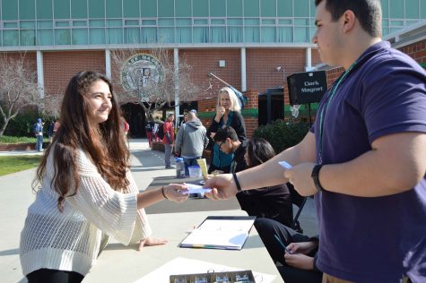 Junior Vice-President Levon Gevorkian sells Winter Formal tickets to Anna Parsamyan. "It was great to go into the bright sun and put up music for the students," he said. "In the end all the work we do is for the juniors as all our profits go towards their prom." 