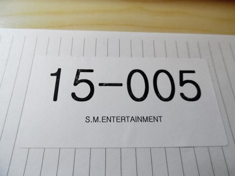 All auditioners get a sticker with their assigned number for identification purposes. Ericka Shin's number was 005, and the 15 refers to the year. 