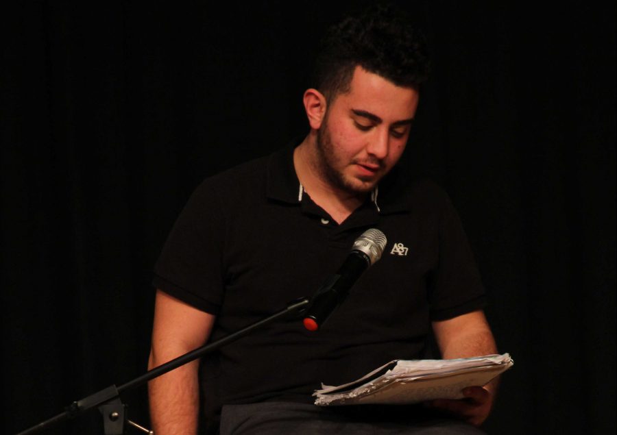 Arka Mardirosian reads his work on stage in front his fellow Creative Writing classmates. 