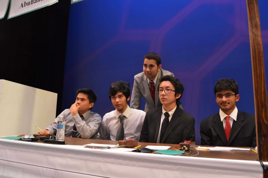 The members of Clarks Scholastic Bowl team sit behind their booth. From left to right: Joshua Valerio, Kevin Abuhana, Aram Arutunyan, Dylan Greicius, and Bhavin Shah.
