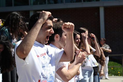 Junior Allen Sotiri throws his hands up in hoped of winning the school spirit contest.