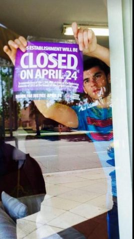 Senior Raffi Jivalagian puts up poster in store front claiming the store to be closed on April 24th. 