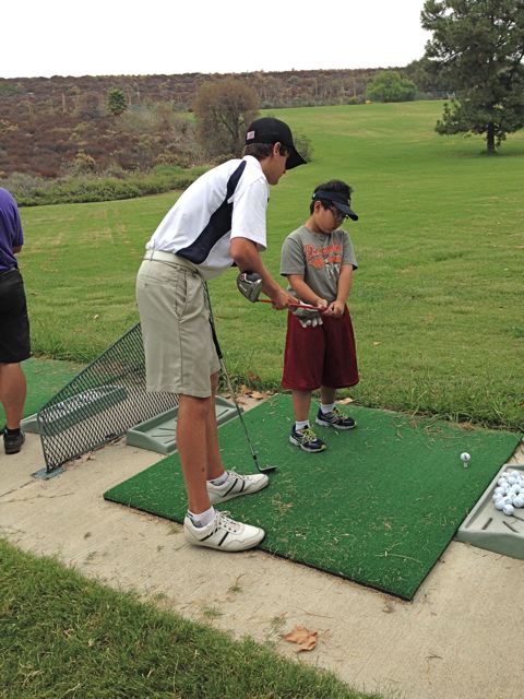 David Holeman teaches a fellow golfer how to grip the club properly during his spare time at the local golfing country club in La Crescenta. 