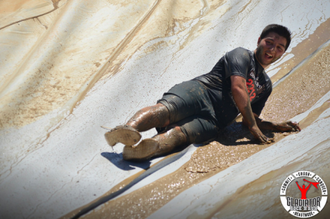 Argeen Ghazarian sliding down one of the mud run obstacles into a pit of mud. 