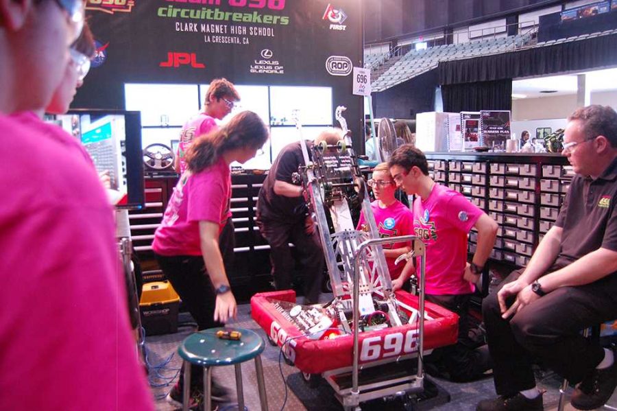 The team works on the robot between matches, making sure the code is correct and all the mechanisms still work.