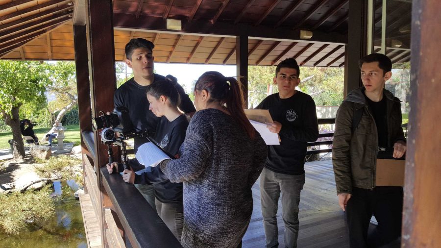 The capstone students filming a scene in the Tea Garden in Brand Park. The park was closed due to the shoot, allowing the team to work in silence.
