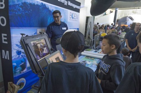 Two boys take control of the ROV at the mobile terminal display. 