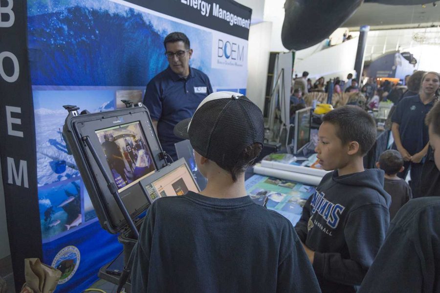 Two boys take control of the ROV at the mobile terminal display.
