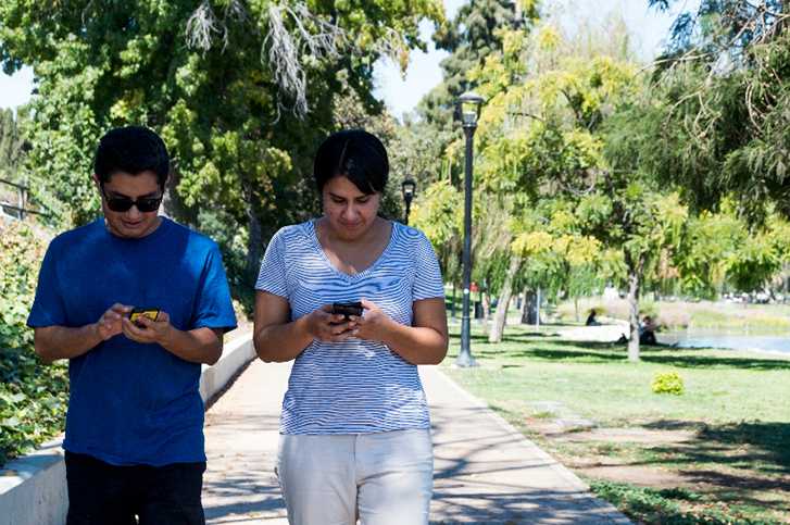 Two Pokemon Go players walking around Echo Park to find Pokemon