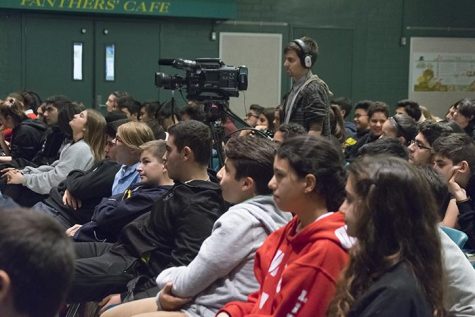 The auditeria was filled with freshmen, sophomores, and juniors. A student from cinematography was filming the presentation.