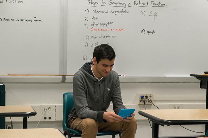 Junior Derick Ambarsoomzadeh demonstrating his attention getter for his speech on Pokémon.