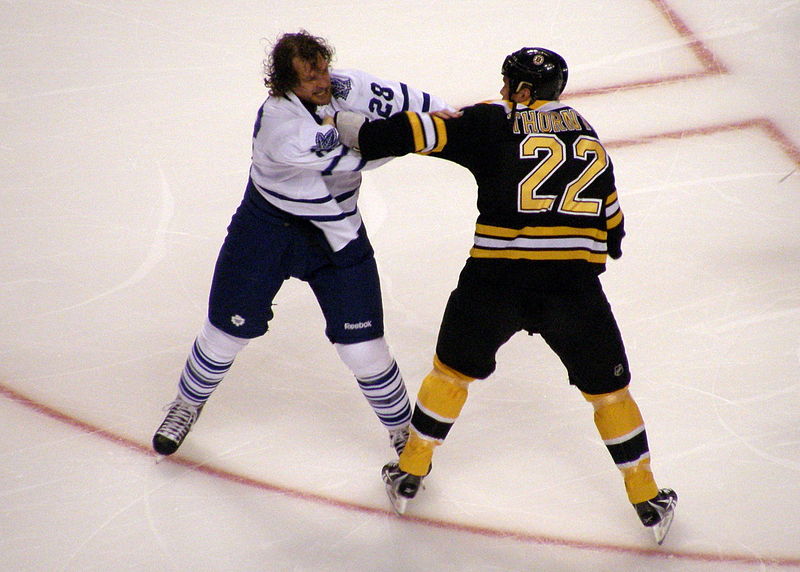 Shawn Thornton of the Boston Bruins and Colton Orr of the Toronto Maple Leafs face off on the ice in the 2011-2012 season. 