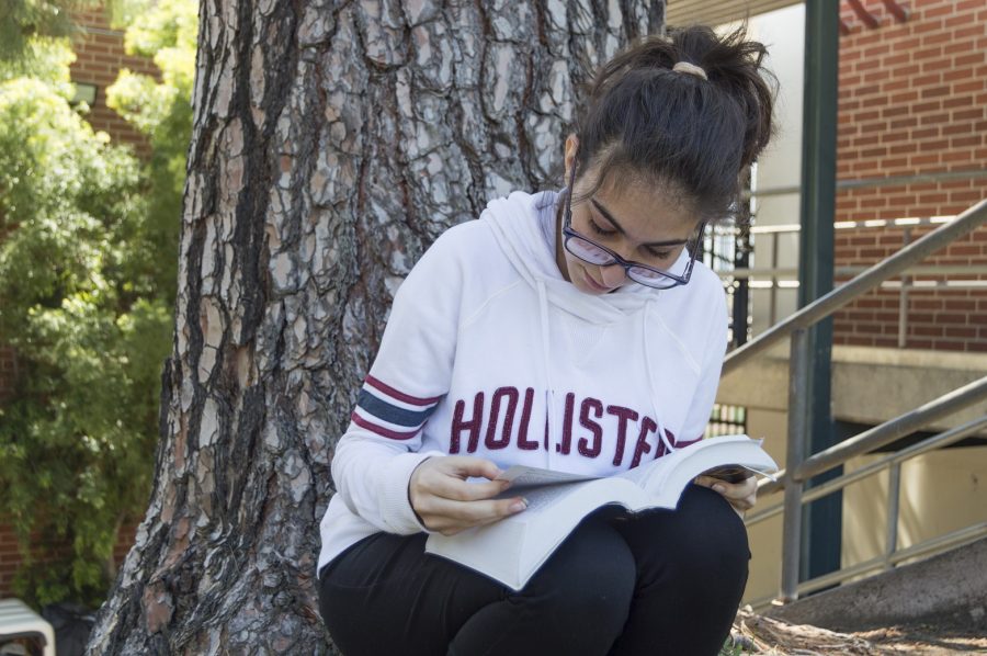 Junior Melanis Panosian reads a book during lunch time