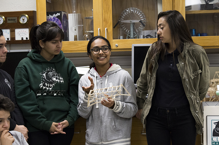 Freshman Amreen Azad, who is in regular physics class, explains how she built her bridge to the whole class.