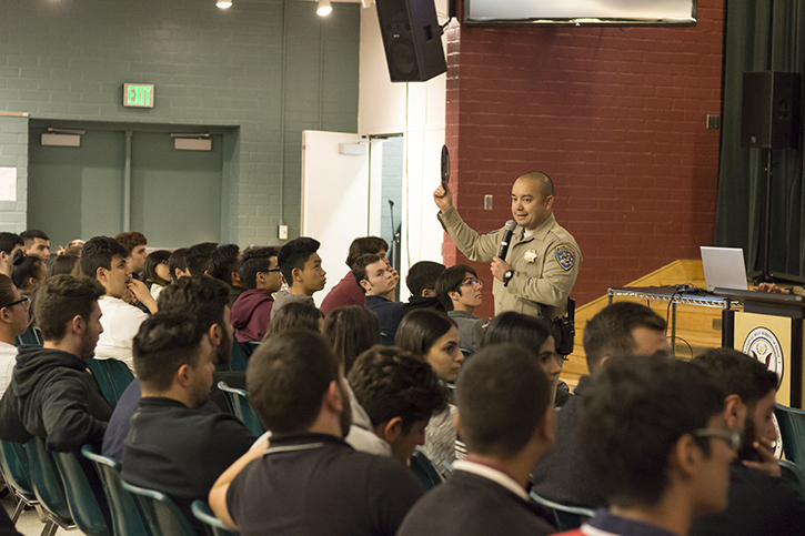 Officer Ryan Bejar shows students the death wheel which shows the different types of distractions leading to death.