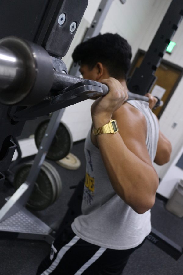 Senior James Tumbucon sets up for warmup squats with an empty barbell at the Glendale YMCA. 