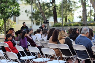 The audience quietly listens to the presenters