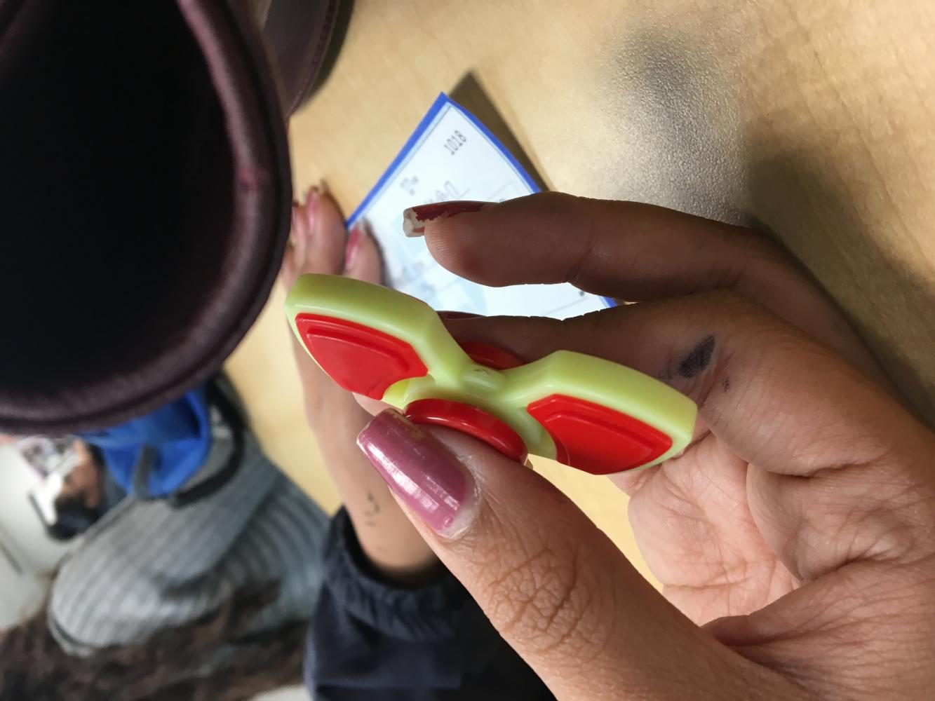 Student plays with fidget spinner