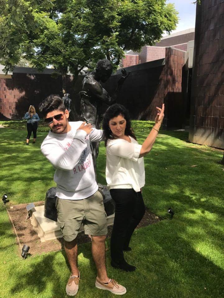 Mrs. Guarino and Erik pose in front of a statue