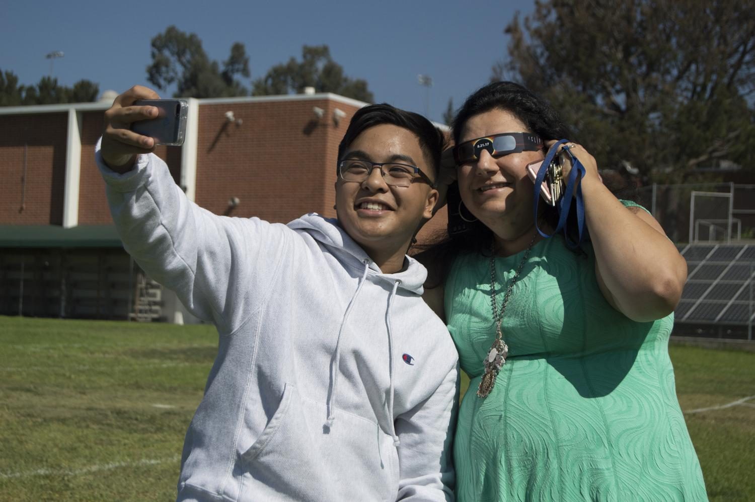 Theodore Supangan and Principal Lena Kortoshian
take a selfie during the solar eclipse.