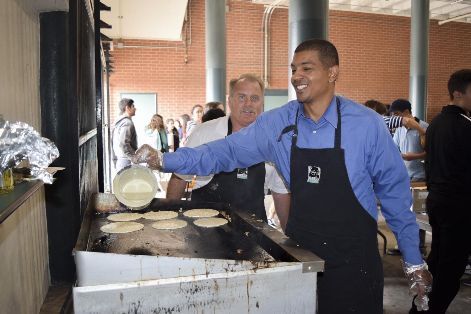 English teacher Conrad Pruitt cooks pancakes for the freshmen