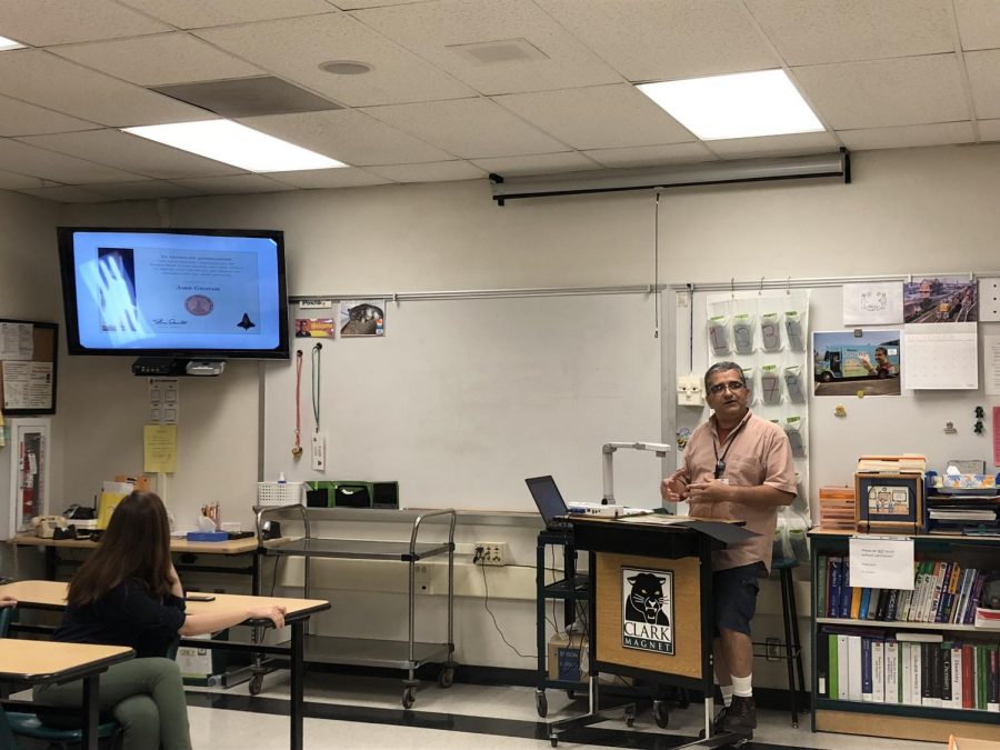Clark teacher Amir Ghavam shows his NASA awards on a PowerPoint.