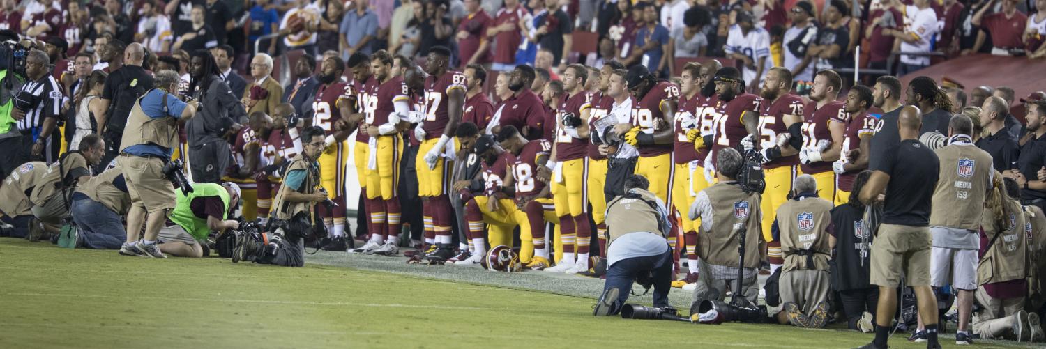 The Washington Redskin players lock arms together during the national anthem. It was one of the many protests sparked by former NFL quarterback Colin Kaepernick in 2016.