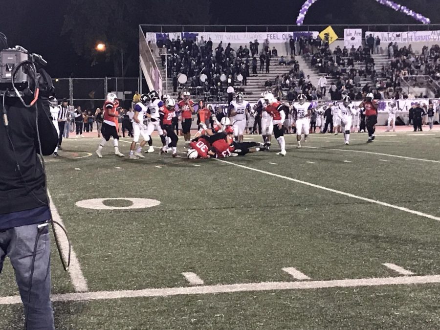 GHS tries to steal the ball by tackling Hoover's team.