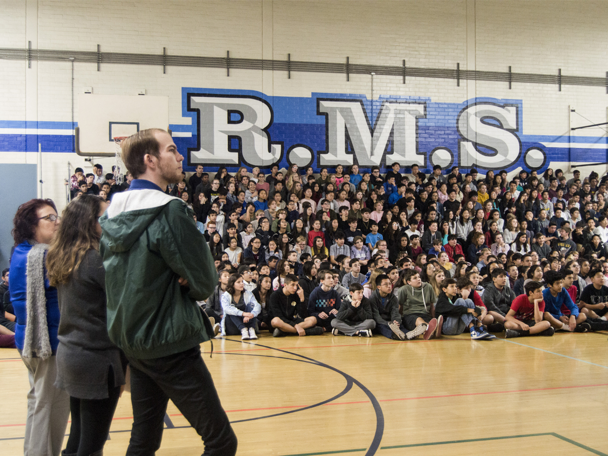 Teacher Eric Kursinski looks upon a group of Rosemont Middle school 8th graders during the presentation.