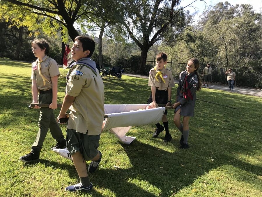 A group of Boy and Girl Scouts practice their first-aid skills at International Scout Day meet-up at Griffith Park.