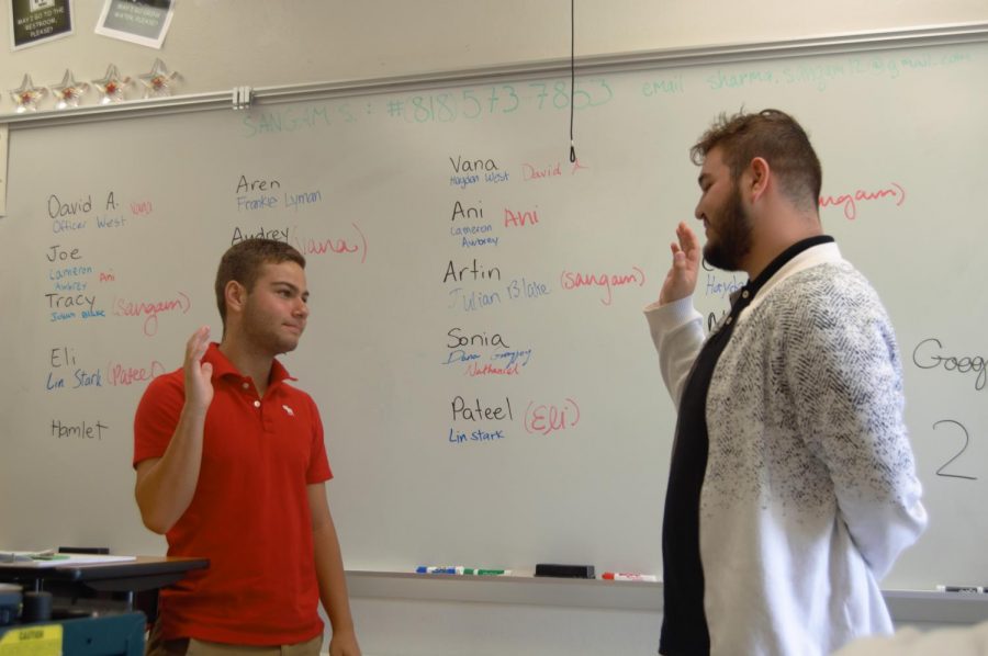 Senior Hamlet Avetisyan swears freshman Artin Keshishian for the audition as practice for the competition before November.