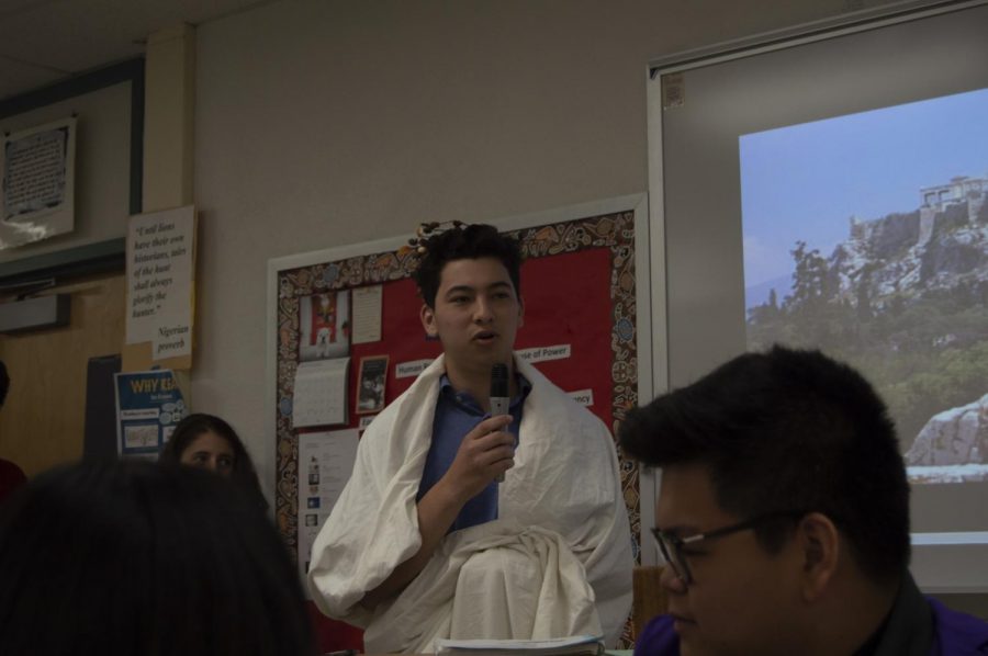 Student Iain Mendez role plays as an ancient Greek civilian during a discussion. 