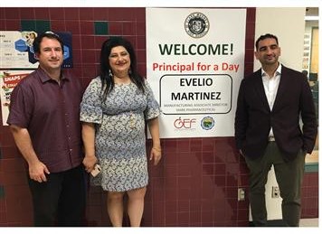 Clark Magnet Principal Lena Kortoshian and Assistant Principal Brian Landisi greet Evelio Martinez in the schools office.