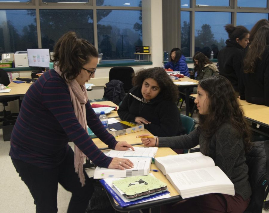 English teacher, Narine Tatevosian, assists juniors Ella Ramamurthy and Aline Zargarian on a writing problem during the SAT class. 
