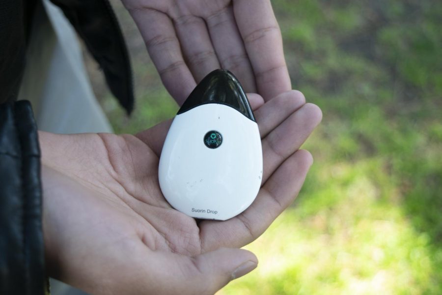 A student holds a Suorin drop despite knowing its consequences.