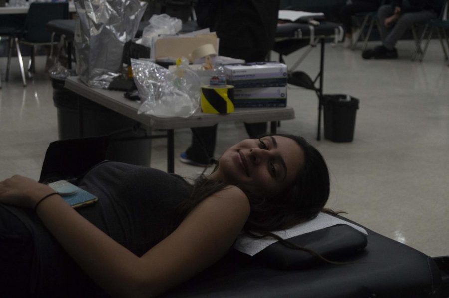 Student waits to get her blood drawn by a Red Cross volunteer.