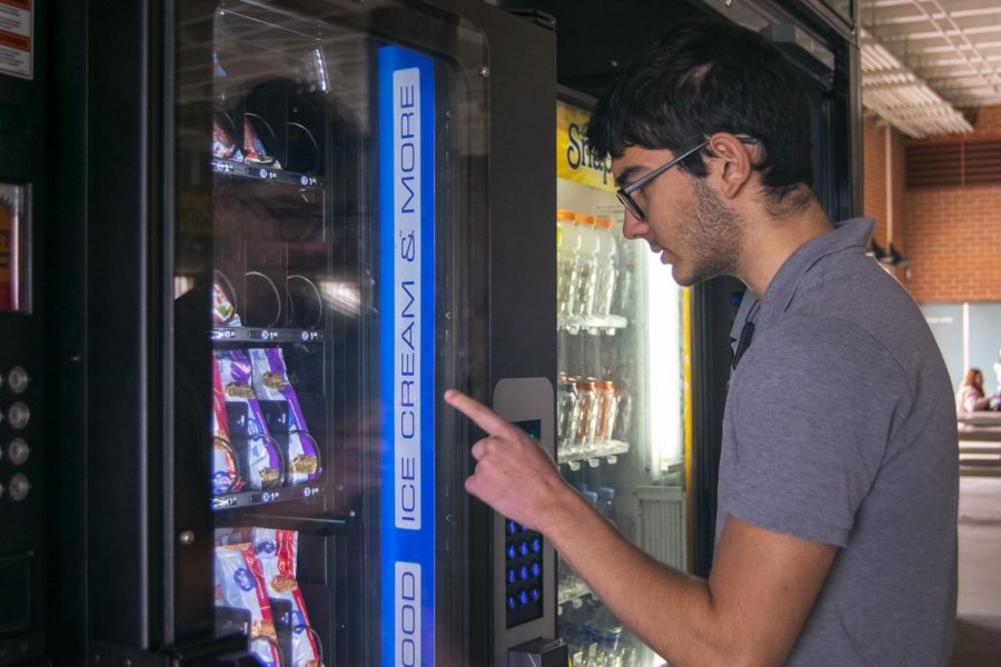 Students cant wait to get their treat from the new vending machine. 