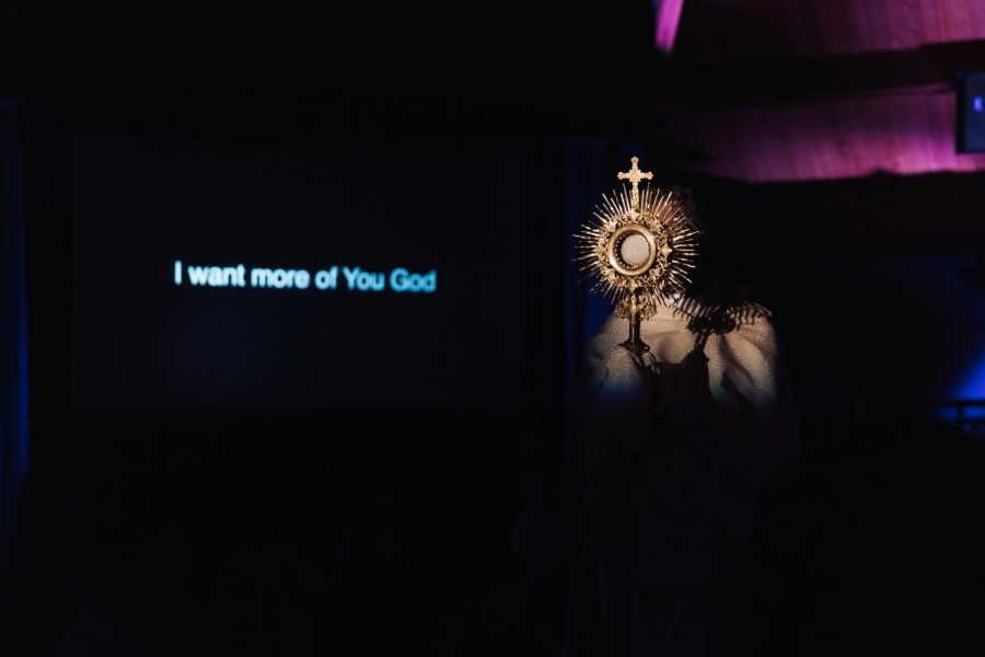 During Adoration, Father Jim of Holy Family Church held up the Eucharist as the LIFE TEEN band sang Set a Fire.