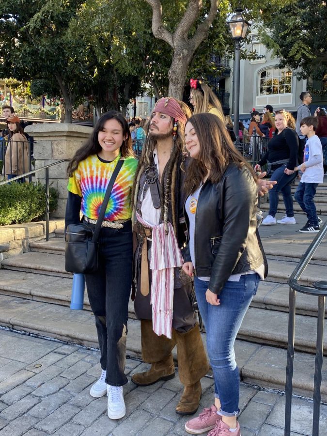 Allyson McCullagh and Emma Tsaturian pose with Captain Jack Sparrow while visiting Frontierland in Disneyland.