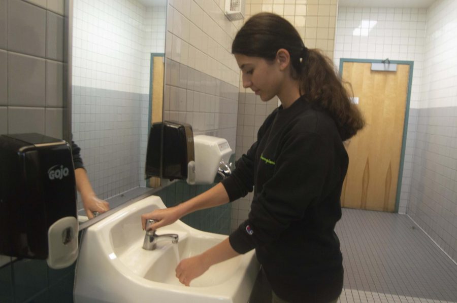 Junior Laura Minassian washes her hands to prevent coronavirus infection. 