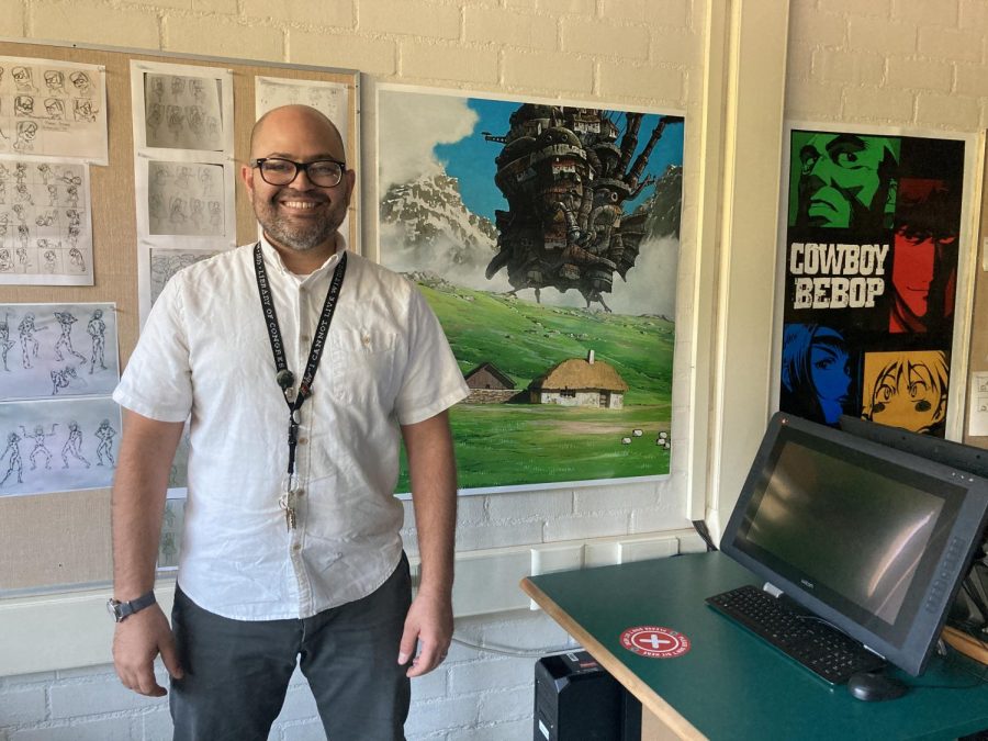 Computer Animation Teacher Anthony Lockhart teaches from his classroom on campus. He’s decorated the classroom with animated media posters, like Howl’s Moving Castle (center) and Cowboy Bebop (right), as well as figure drawings from class exercises (left). 