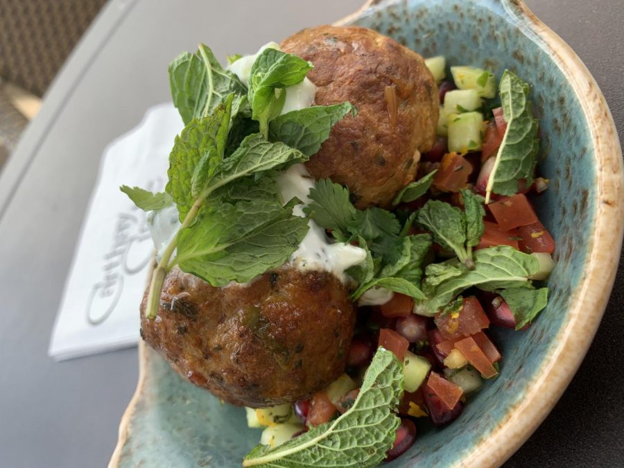 Morrocan meatballs are full of rich flavor with a pomegranate relish, cucumber and tomato salad, and topped with minted yogurt.