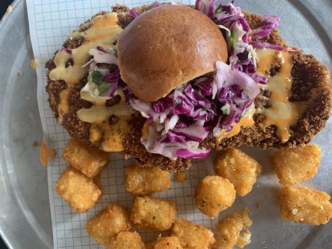  The Not So Little Chicken Sandwich is full of flavor with a fried chicken breast, red chili sauce, and pickled cabbage slaw