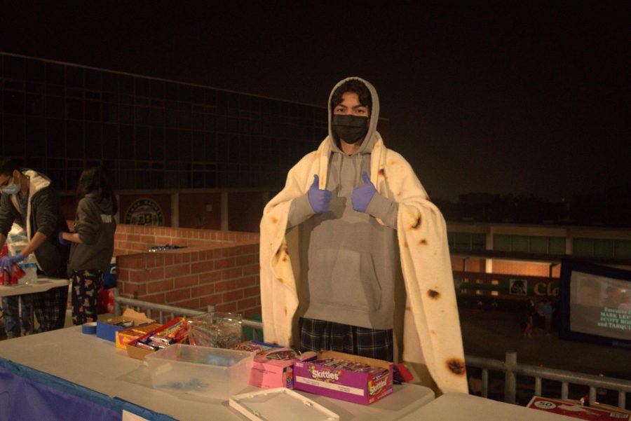 Junior ASB member David Babayan sells candy at the annual movie night. 
