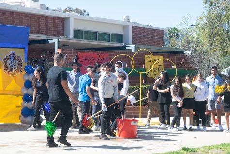 Students enjoyed dripping each other with water balloons at the end of the obstacle race game.
