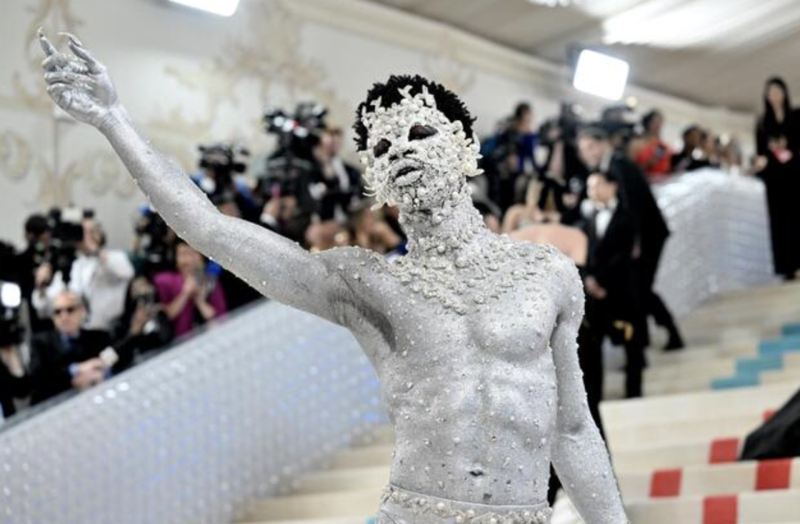 Lil Nas X at the Met posing in his fashion statement, covered from head to heels in rhinestones. 